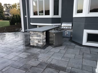 outdoor patio with grill and fridge